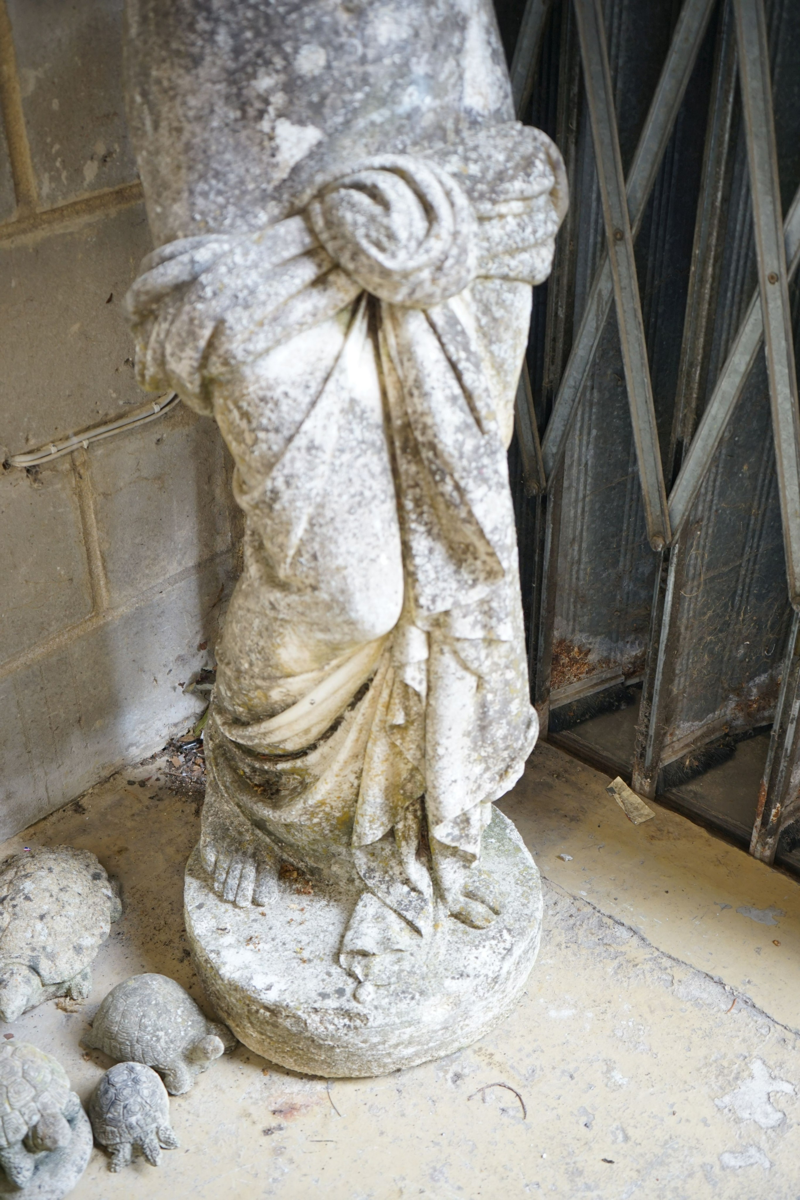 A weathered reconstituted stone garden statue of a robed female figure, height 155cm